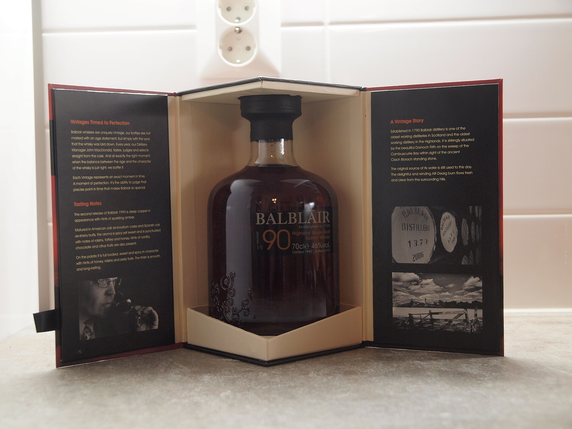 A bottle of single malt Scotch whisky beside a filled tasting glass